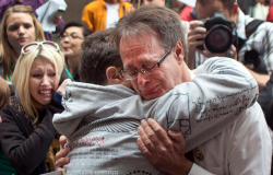 Canadian marijuana activist Marc Emery cries while embracing a friend before being extradited to the U.S. on charges of distributing marijuana seeds.